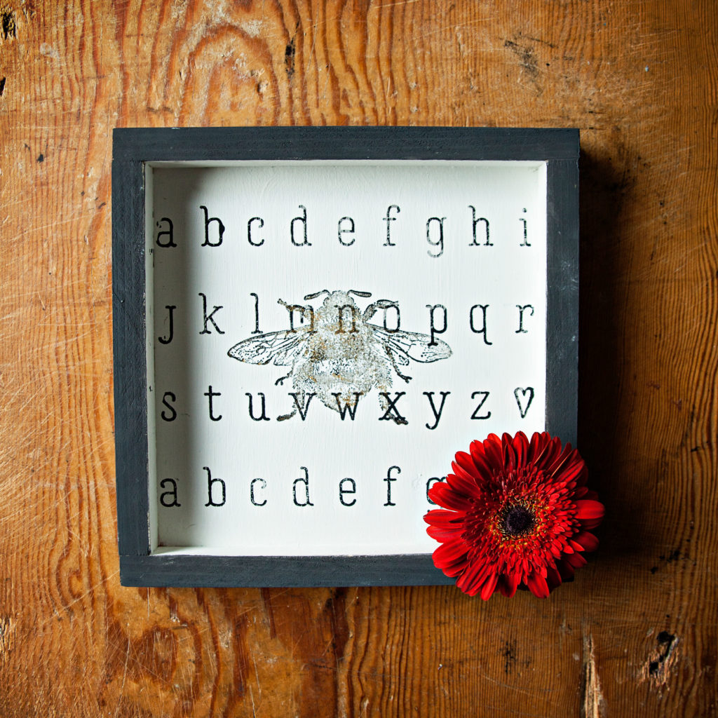 Learn how to quickly DIY this cute alphabet stencil and bee stamp wall art craft with A Makers’ Studio.